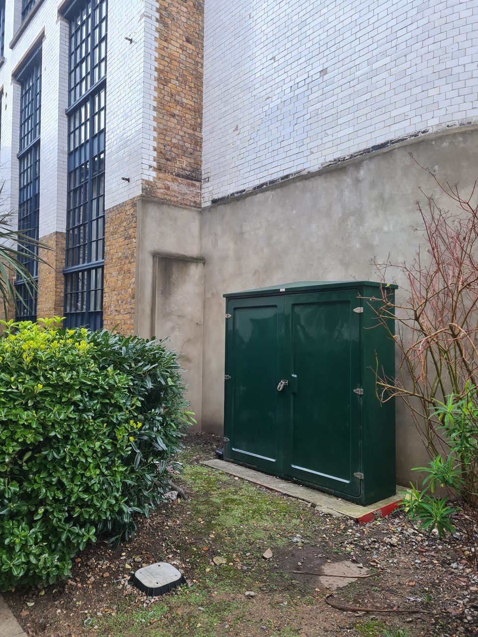 External electrical service cabinet beside plant room wall